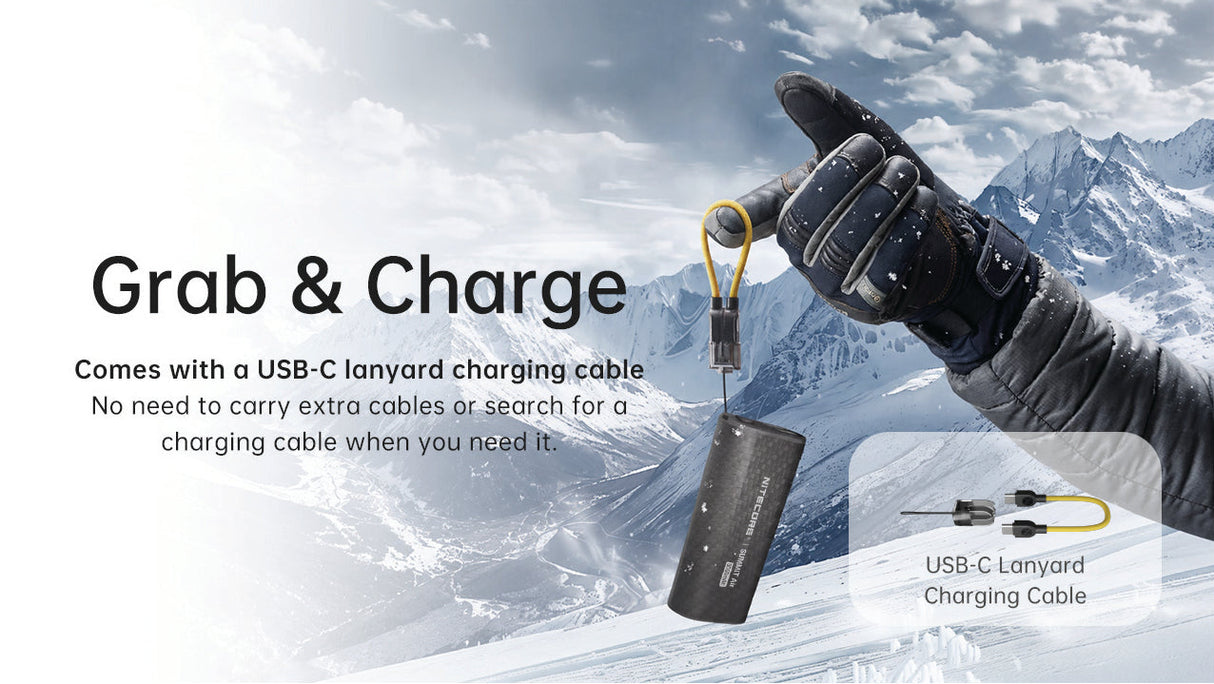 A gloved hand holds a black cylindrical portable charger with a yellow lanyard against a snowy mountain backdrop. Large text reads 'Grab & Charge,' with smaller copy about a USB-C lanyard charging cable and a small inset showing the cable connector details.