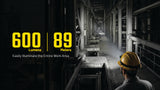 A dark industrial interior scene with a person in a yellow hard hat seen from behind, with large yellow text reading '600 Lumens' and '89 Meters' and smaller text 'Easily Illuminate the Entire Work Area.' This is not a clean product shot and appears to be a marketing/demo scene rather than a standalone product image.
