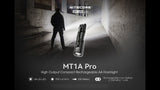 Man illuminating a concrete hallway with MT1A Pro promotional content; flashlight graphic and text "MT1A Pro High Output Compact Rechargeable AA Flashlight".